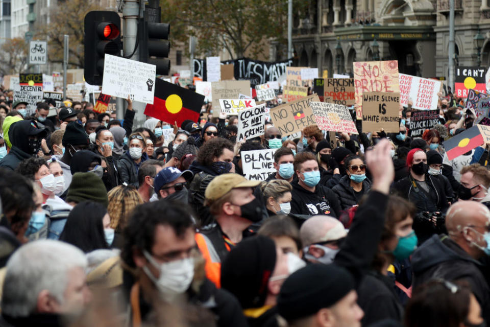 Protesters holding up signs on Bourke Street during the Black Lives Matter protest in Melbourne. 