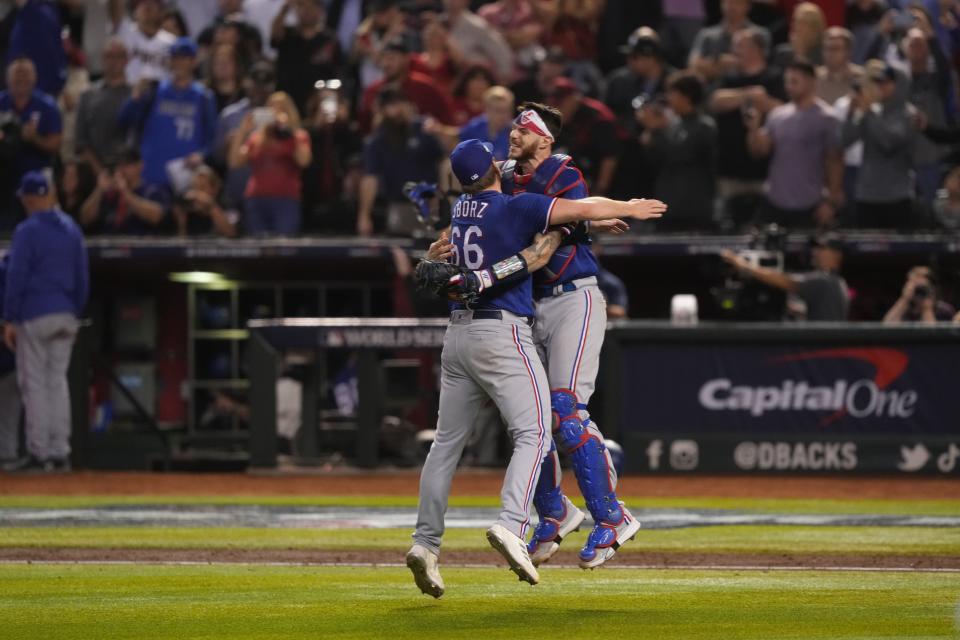 Rangers relief pitcher Josh Sborz celebrates with catcher Jonah Heim after defeating the Diamondbacks to win the World Series.
