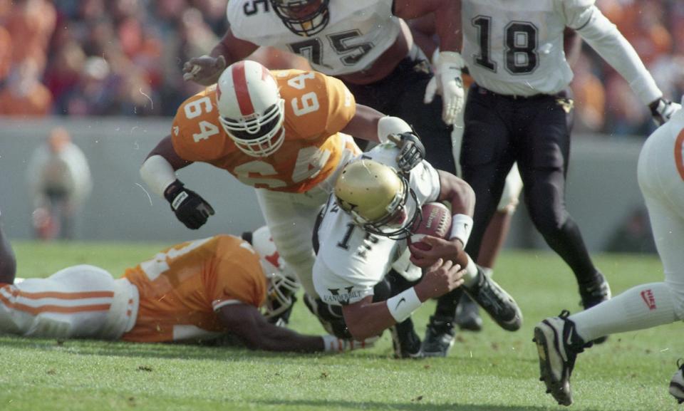 Vanderbilt's quarterback Damian Allen gets sacked by Tennessee's Steve White on November 25, 1995.