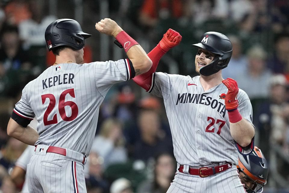 Minnesota Twins' Ryan Jeffers (27) celebrates with Max Kepler (26) after hitting a home run against the Houston Astros during the 10th inning of a baseball game Monday, May 29, 2023, in Houston. (AP Photo/David J. Phillip)