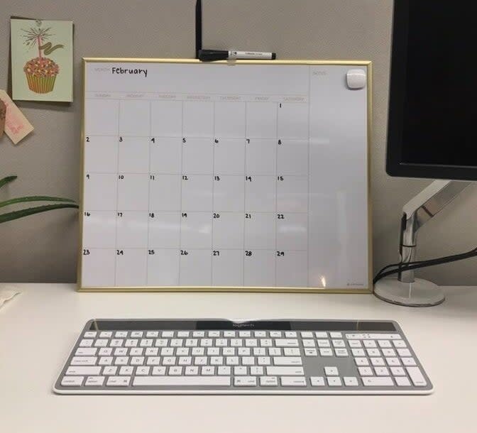 a dry erase calendar on a desk