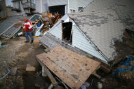 David Mccue stands near the roof to his beach house that was completely demolished by Superstorm Sandy on November 25, 2012 in Ortley Beach, New Jersey. New Jersey Gov. Christie estimated that Superstorm Sandy cost New Jersey $29.4 billion in damage and economic losses. (Photo by Mark Wilson/Getty Images)