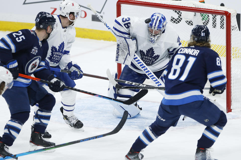 Toronto Maple Leafs goaltender Jack Campbell (36) makes the save on a shot by Winnipeg Jets' Kyle Connor (81) during the second period of an NHL hockey game Wednesday, March 31, 2021, in Winnipeg, Manitoba. (John Woods/The Canadian Press via AP)