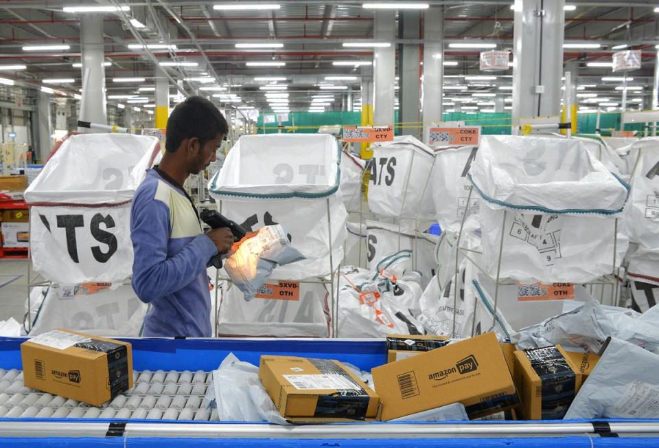 Amazon India workers package boxes for delivery at a warehouse on the outskirts of Bengaluru in 2018 (AFP via Getty)