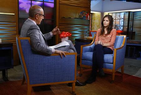 Amanda Knox, appearing on NBC News' "Today" show, speaks with host Matt Lauer (L) in New York, in this image released by NBC on September 20, 2013. REUTERS/Peter Kramer/NBC/Handout via Reuters