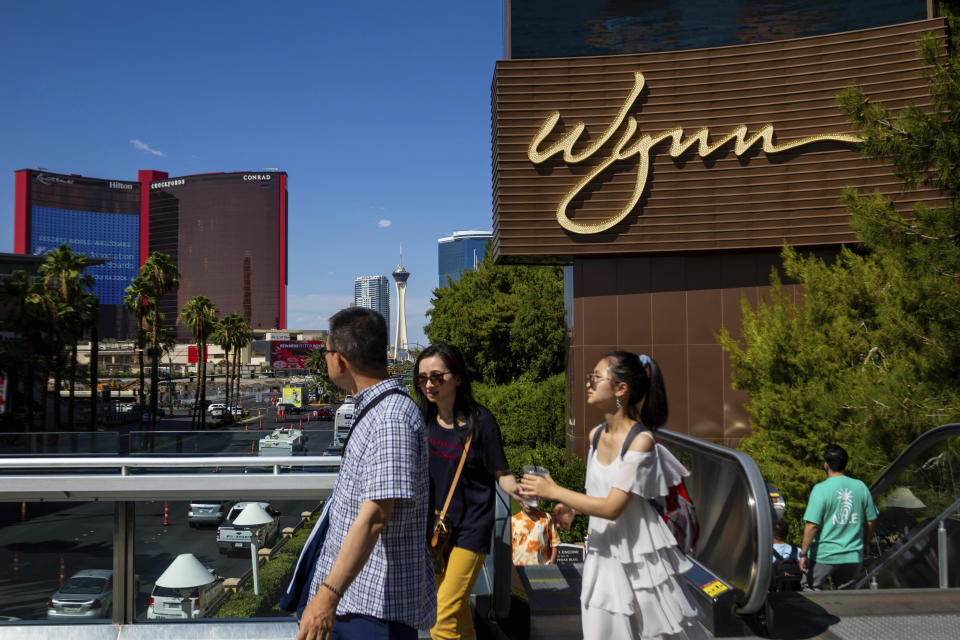 People walk near the Wynn Las Vegas resort on Wednesday, July 26, 2023, in Las Vegas. Casino mogul Steve Wynn's long legal fight with Nevada gambling regulators over claims of workplace sexual misconduct is expected to end Thursday with a settlement calling for him to pay a $10 million fine and cut virtually all ties to the industry he helped shape in Las Vegas. (AP Photo/Ty ONeil)