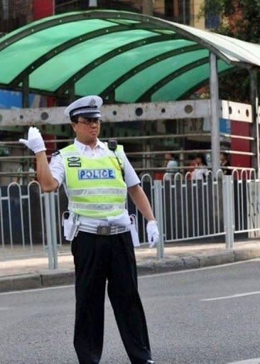 This file picture shows then-Chongqing police chief Wang Lijun directing traffic in order to set an example to his policemen in southwest China's Chongqing municipality, in 2010. Wang, Bo Xilai's former right-hand man, will go on trial in southwest China next week, a court said on Friday, the latest stage in a scandal that has rocked the Communist party ahead of a 10-yearly power handover