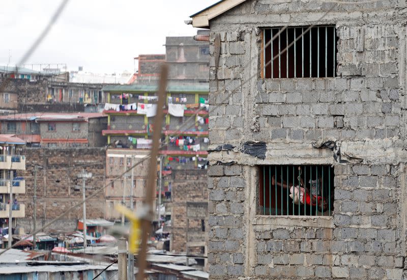 Bruno Ngetich swings at a staircase inside a building in the Mathare slums of Nairobi