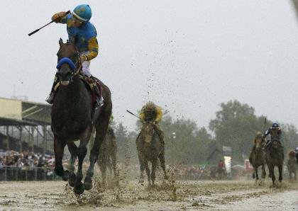 Jockey Victor Espinoza celebrates aboard American Pharoah after winning the Preakness. (AP)