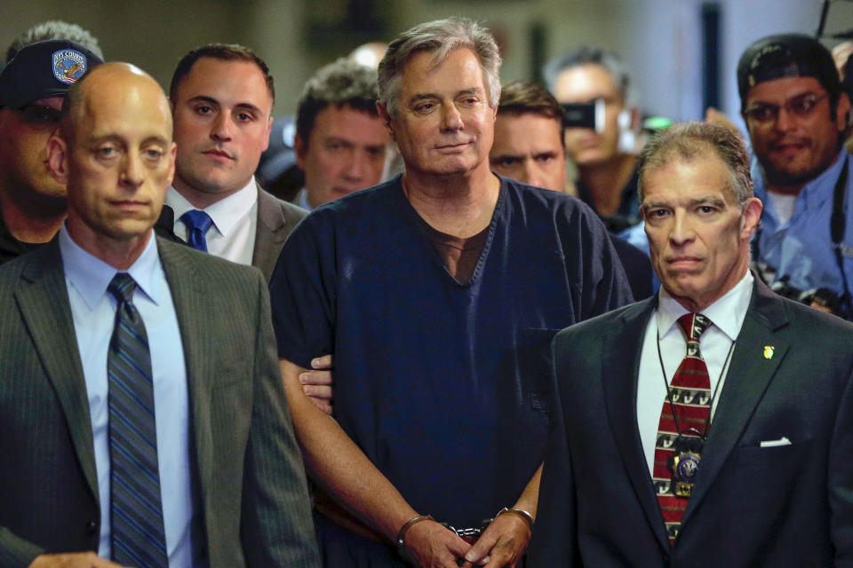 FILE - In this June 27, 2019 file photo, Paul Manafort, center, arrives at court in New York. The arrest of President Donald Trump’s former chief strategist Steve Bannon adds to a growing list of Trump associates ensnared in legal trouble. They include the president's former campaign chair, Manafort, whom Bannon replaced, his longtime lawyer, Michael Cohen, and his former national security adviser, Michael Flynn. (AP Photo/Seth Wenig, File)