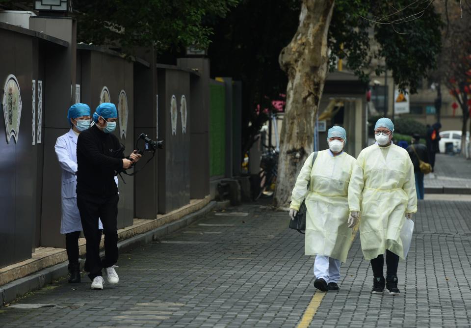 HANGZHOU, CHINA - FEBRUARY 12 2020: Masked people shoot propaganda footage of the fight against Covid-19 in Hangzhou in east China's Zhejiang province Wednesday, Feb. 12, 2020.- PHOTOGRAPH BY Feature China / Barcroft Media (Photo credit should read Feature China/Barcroft Media via Getty Images)