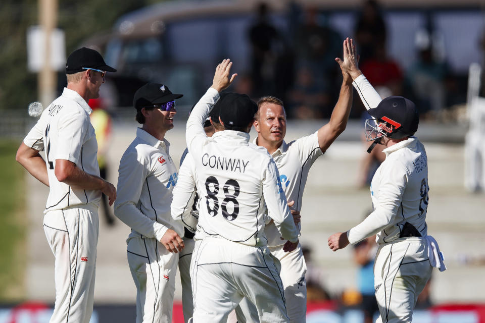 New Zealand players celebrate the wicket of Najmul Hossain Shanto of Bangladesh on day two of the first cricket test between Bangladesh and New Zealand at Bay Oval in Mount Maunganui, New Zealand, Sunday, Jan. 2, 2022. (Aaron Gillions/Photosport via AP)