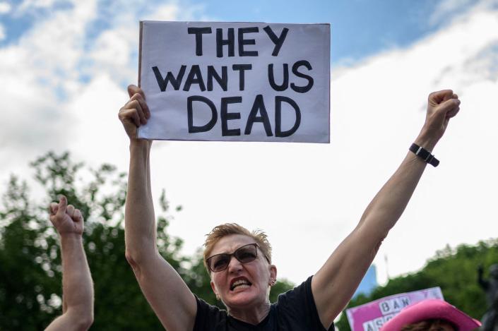 A protester holds a sign that reads &quot;They Want Us Dead&quot; during a protest against gun violence by the activist group &quot;Gays against Guns&quot; in New York City on June 23, 2022.