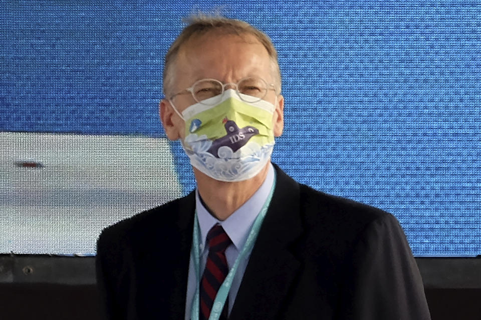 Director of the American Institute in Taiwan, Brent Christensen wears a mask with the design showing Taiwan's domestic submarine as he attends a ceremony to inaugurate the production of these submarines at the CSBC Corp's shipyards in the southern city of Kaohsiung, Taiwan on Tuesday, Nov. 24, 2020. Taiwan's President Tsai Ing-wen inaugurated the production of domestically-made submarines Tuesday in the southern city of Kaohsiung, in a step forward for the island's defense strategy at a time of elevated tensions with China. (AP Photo/Huizhong Wu)