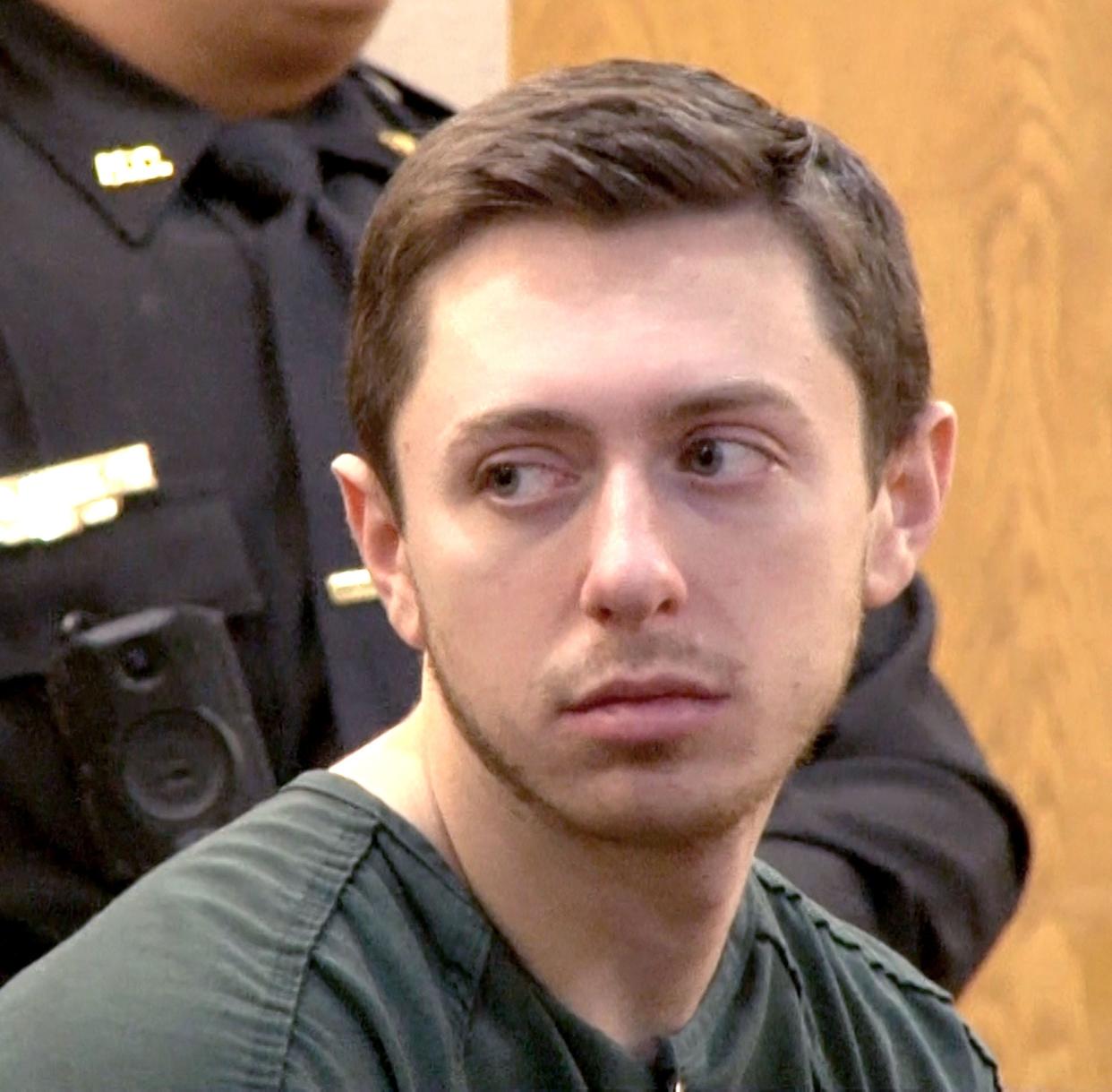 Thomas R. Carraher, a Tinton Falls elementary school teacher accused of trying to solicit sex from a minor, looks back to his family during his detention hearing before Superior Court Judge Paul X. Escandon in Freehold Monday, January 29, 2024.