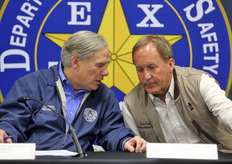 Gov. Greg Abbott, left, and Attorney General Ken Paxton confer after an Operation Lone Star roundtable discussion at the Texas Department of Public Safety Weslaco Regional Office on Thursday, March 10 in Weslaco.