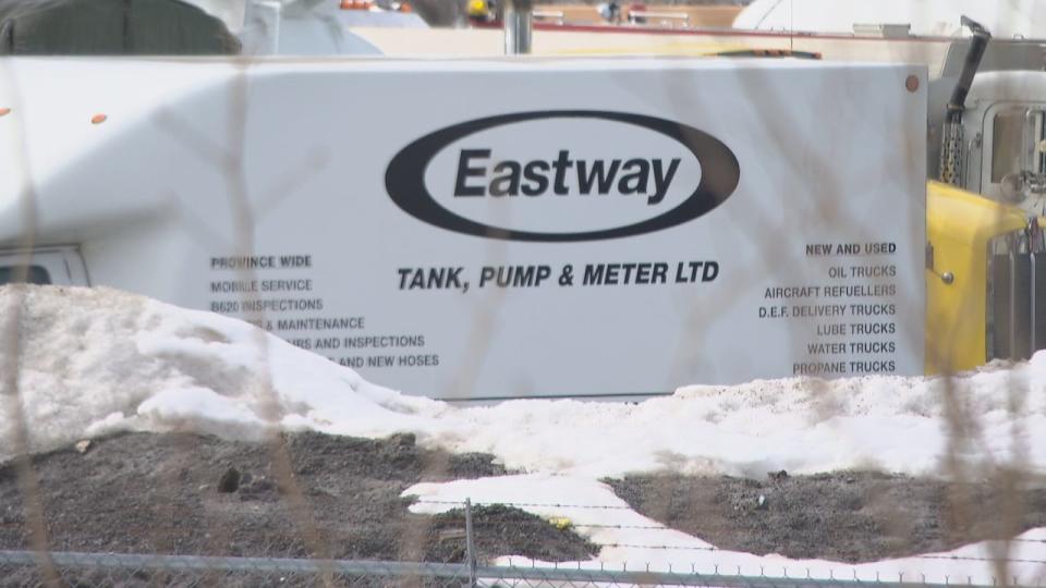 Eastway Tank sign Ottawa March 2022 through the fence