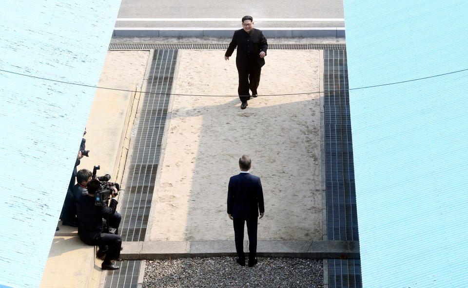 FILE - In this April 27, 2018 file photo, North Korean leader Kim Jong Un, top, walks toward South Korean President Moon Jae-in, bottom, at the border village of Panmunjom in the Demilitarized Zone. North and South Korea began removing mines at two sites inside their heavily fortified border Monday, Oct. 1, 2018, as part of their recent deals to ease decades-long military tensions. They will likely end up pulling out a very small portion of an estimated 2 million mines littered inside and near the 248-kilometer (155-mile) -long, 4-kilometer (2.5-mile) -wide Demilitarized Zone. But it would be the rivals’ first joint demining work in more than a decade and comes amid international diplomacy aimed at ridding North Korea of its nuclear weapons.(Korea Summit Press Pool via AP, File)