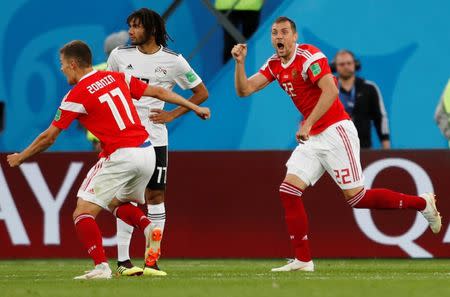 Soccer Football - World Cup - Group A - Russia vs Egypt - Saint Petersburg Stadium, Saint Petersburg, Russia - June 19, 2018 Russia's Artem Dzyuba and Roman Zobnin celebrate after Egypt's Ahmed Fathy scored Russia's first with an own goal REUTERS/Lee Smith