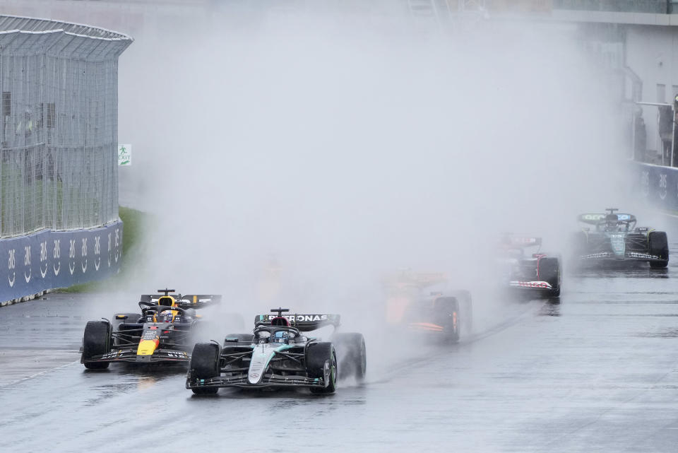 Mercedes driver George Russell, second from left, of the United Kingdom, leads as Red Bull driver Max Verstappen, of The Netherlands, drives during the Canadian Grand Prix Formula 1 car race, in Montreal, Sunday, June 9, 2024. (Christinne Muschi/The Canadian Press via AP)