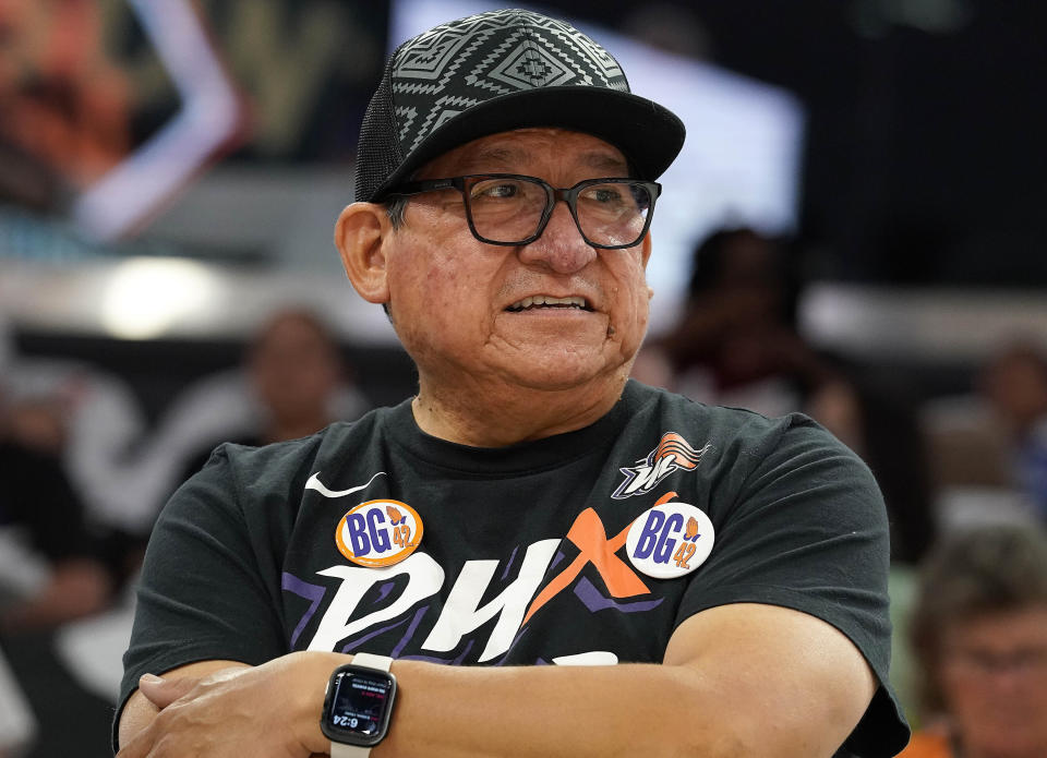 Phoenix Mercury fan Michael Augustine wears buttons referring to Mercury's Brittney Griner before a WNBA basketball game between the Mercury and the Las Vegas Aces, Friday, May 6, 2022, in Phoenix. Griner has been detained in Russia since Feb. 17 after authorities at the Moscow airport said they found vape cartridges that allegedly contained oil derived from cannabis in her luggage. (AP Photo/Darryl Webb)