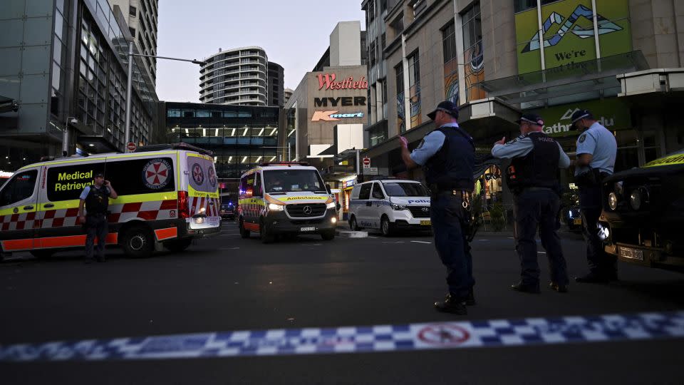 Emergency service workers gather near Bondi Junction after multiple people were stabbed inside the Westfield shopping centre in Sydney on April 13. - Steven Saphore/AAP/Reuters