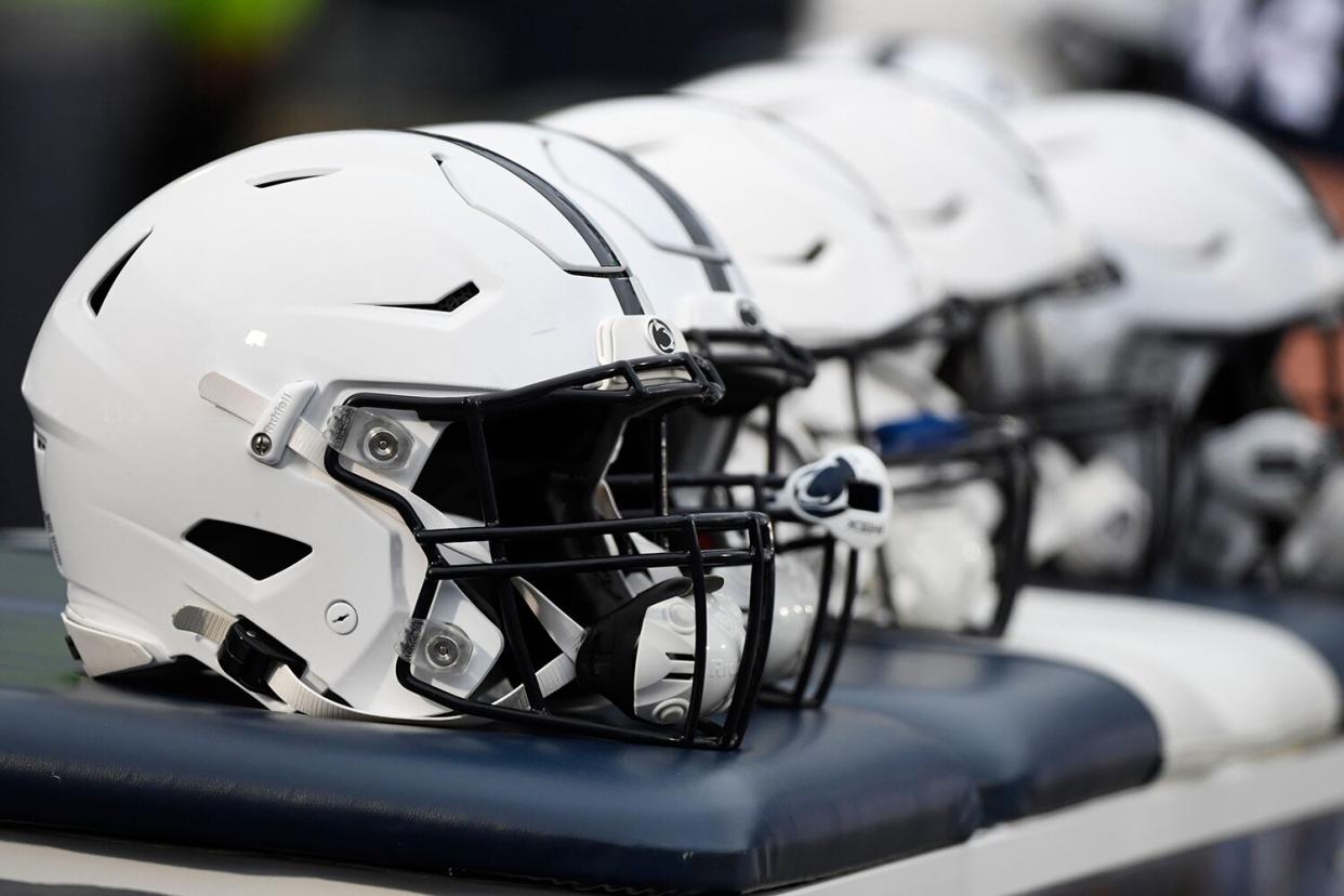 Mandatory Credit: Photo by Barry Reeger/AP/Shutterstock (12601616ao) Penn State helmets sit on the team bench against Michigan during an NCAA college football game in State College, Pa.on Michigan Penn St Football, State College, United States - 13 Nov 2021