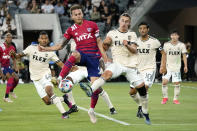 Dallas FC defender Bressan, center left, reaches for ball as Los Angeles FC's Carl Jennings, center right, defends during the first half of an MLS soccer match Wednesday, June 23, 2021, in Los Angeles. (AP Photo/Marcio Jose Sanchez)