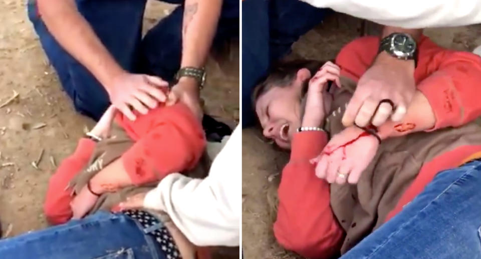 Video taken at the scene shows the woman grimacing in pain as bystanders tend to her wounded arm. Source: Twitter/Adam Wilkerson