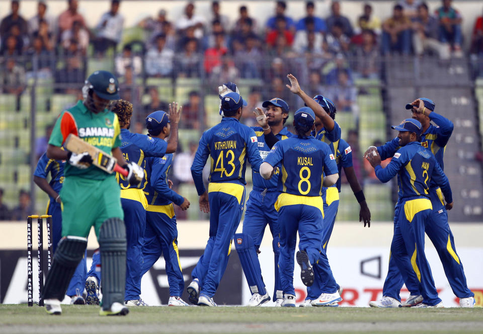 Sri Lankan cricket team celebrates the wicket of Bangladesh’s Shamsur Rahman during their second one-day international (ODI) cricket match in Dhaka, Bangladesh, Thursday, Feb. 20, 2014. (AP Photo/A.M. Ahad)