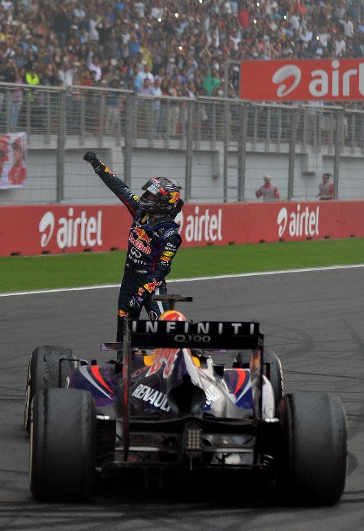 Red Bull driver Sebastian Vettel of Germany celebrates on his car