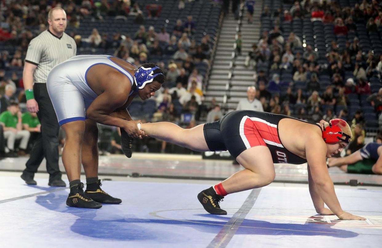 Olympic’s Kevin Hudson pulls Othello’s Mason Perez by the foot during their 285-pound championship bout at Mat Classic on Friday, Feb. 17, 2024.