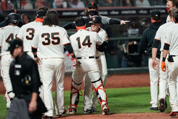 PHOTO: San Francisco Giants catcher Chadwick Tromp  hugs right fielder Mike Yastrzemski after hitting a walk off home run to win the game against the San Diego Padres at Oracle Park, July 29, 2020. (Stan Szeto/USA TODAY Sports via Reuters)