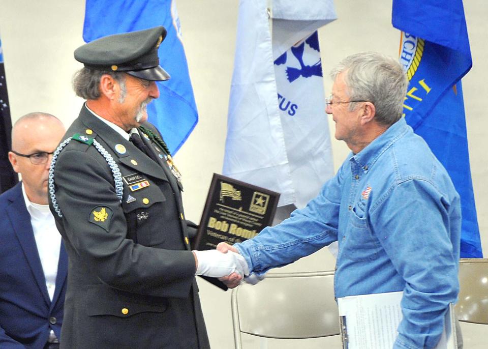 Vietnam-era veteran Jeff Sampsel (left) presented Bob Romig with the 2023 Veteran of the Year Award during the Veterans Day Service at the Wayne County Fairgrounds.