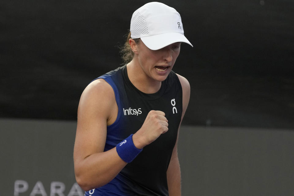 Iga Swiatek, of Poland, celebrates winning a point during a women's singles final of the WTA Finals tennis championships against Jessica Pegula, of the United States, in Cancun, Mexico, Monday, Nov. 6, 2023. (AP Photo/Fernando Llano)