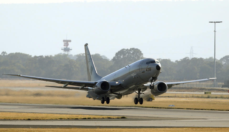 A U.S. Navy P8 Poseidon takes off from Perth Airport en route to rejoin the ongoing search operations for missing Malaysia Airlines Flight 370 in Perth, Australia, Sunday, April 13, 2014. Military planes and ships from seven nations continue to scourer the Indian Ocean off the coast of western Australia for Flight 370 in one of the largest maritime multi-nation searches in history. (AP Photo/Rob Griffith)