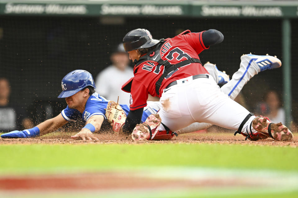 Cleveland Guardians' Bo Naylor (23) tags out Kansas City Royals' Nicky Lopez, left, at home plate on an RBI double hit by Maikel Garcia during the eighth inning of a baseball game, Saturday, July 8, 2023, in Cleveland. (AP Photo/Nick Cammett)