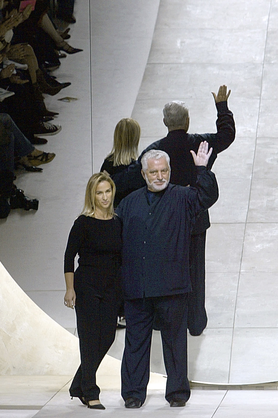 FILE - French-Spanish fashion designer Paco Rabanne, right, flanked by Rosemary Rodriguez, artistic director of the Paco Rabanne fashion house, acknowledges applause after the presentation of his spring-summer 2003 ready-to-wear collection, Monday Oct. 7, 2002 in Paris. The Spanish-born pace-setting designer Paco Rabanne known for perfumes sold worldwide and his metallic, space-age fashions, has died, the group that owns his fashion house announced on its website Friday Feb.3, 2023. He was 88. (AP Photo/Michel Euler, File)