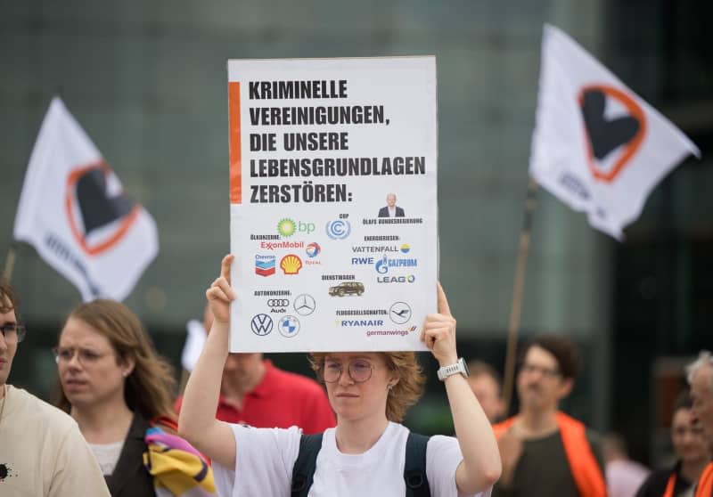 A protester holds a sign reading 