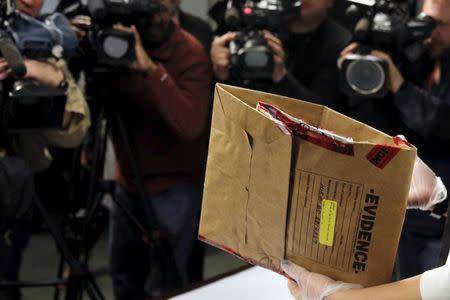 A court official prepares display pieces of shrapnel taken from the body of Boston Marathon bombing victim Krystle Campbell and presented as evidence in the trial of Dzhokhar Tsarnaev in Boston, Massachusetts March 26, 2015. REUTERS/Brian Snyder