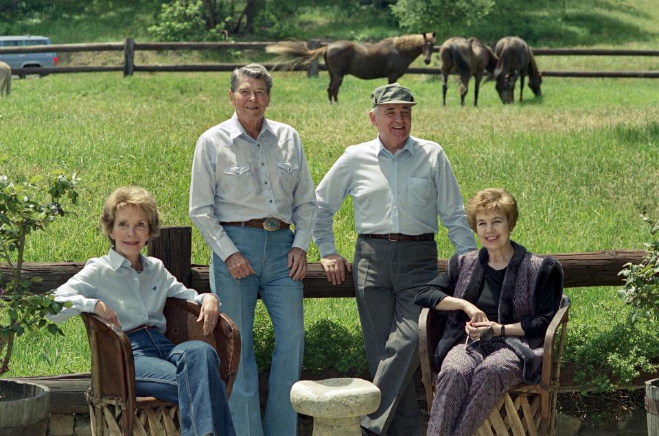 FILE - U.S. former President Ronald Reagan, his wife Nancy, and former Soviet President Mikhail Gorbachev and wife, Raisa pose for photographs on Sunday, May 3, 1992 at Rancho del Cielo, the Reagan's 688-acre ranch 30 miles north of Santa Barbara, Calif. When Mikhail Gorbachev is buried Saturday at Moscow's Novodevichy Cemetery, he will once again be next to his wife, Raisa, with whom he shared the world stage in a visibly close and loving marriage that was unprecedented for a Soviet leader. Gorbachev's very public devotion to his family broke the stuffy mold of previous Soviet leaders, just as his openness to political reform did. (AP Photo/Bob Galbraith, File)