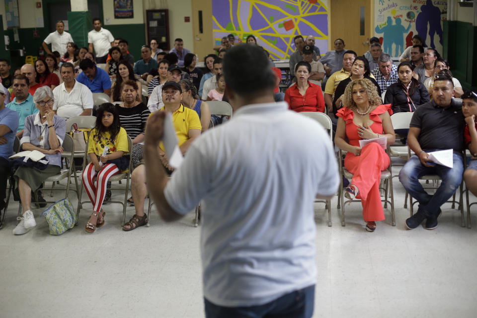 n this Sunday, June 30, 2019 photo Jose Palma, foreground, head of the Massachusetts Temporary Protected Status Committee, address a TPS meeting in Somerville, Mass. TPS is a program that offers temporary legal status to some immigrants in the U.S. who can't return to their country because of war or natural disasters. (AP Photo/Steven Senne)