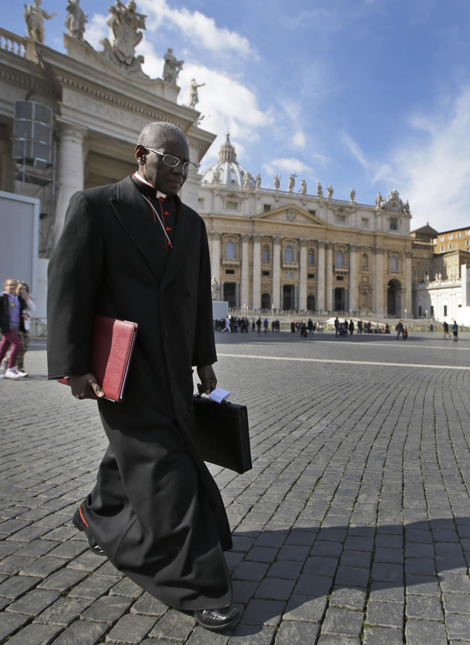 FILE - In this Monday, March 4, 2013 file photo, Cardinal Robert Sarah, of Guinea, walks in St. Peter's Square after attending a cardinals' meeting, at the Vatican. Retired Pope Benedict XVI wrote the book, "From the Depths of Our Hearts: Priesthood, Celibacy and the Crisis of the Catholic Church," along with his fellow conservative, Guinean Cardinal Robert Sarah, who heads the Vatican's liturgy office and has been a quiet critic of Francis. (AP Photo/Andrew Medichini, File)