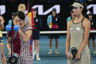 Japan's Shuko Aoyama, left, reacts during a post macyth speech with Ena Shibahara following their loss to Czech Republic's Barbora Krejcikova and Katerina Siniakova in the women's doubles final at the Australian Open tennis championship in Melbourne, Australia, Sunday, Jan. 29, 2023. (AP Photo/Aaron Favila)