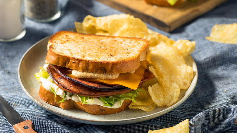 Fried bologna sandwich with chips