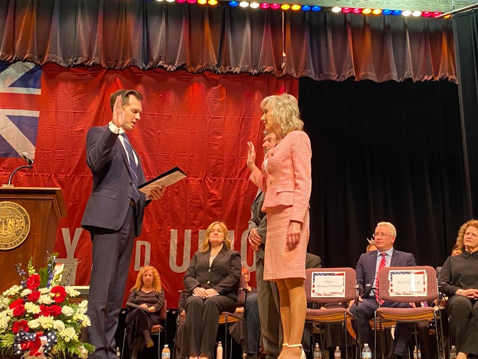 U.S. Rep. Jake Auchincloss, left, swears in Taunton Mayor Shaunna O' Connell for her third term at the inauguration ceremony on Tuesday, Jan. 2, 2024, in the auditorium of the former Coyle & Cassidy high school. In his speech, Auchincloss said he and O'Connell have "shared priorities" when it comes to numerous issues, including funding improvements to infrastructure in the city and region.