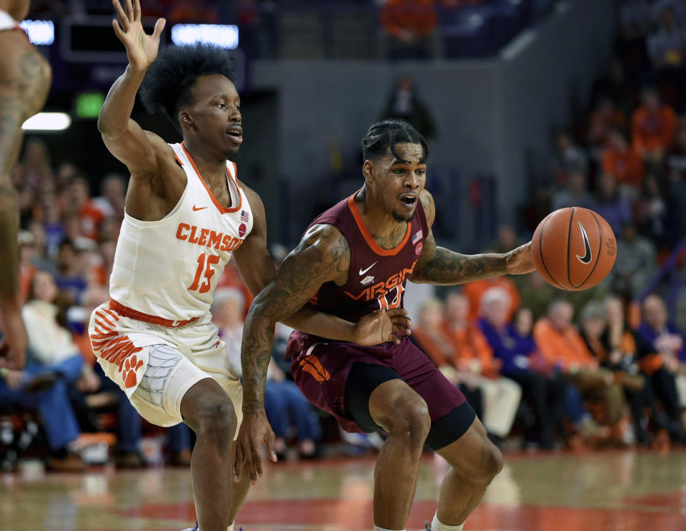 Virginia Tech's Ahmed Hill drives against Clemson's John Newman III (15) during the first half of an NCAA college basketball game Saturday, Feb. 9, 2019, in Clemson, S.C.. (AP Photo/Richard Shiro)