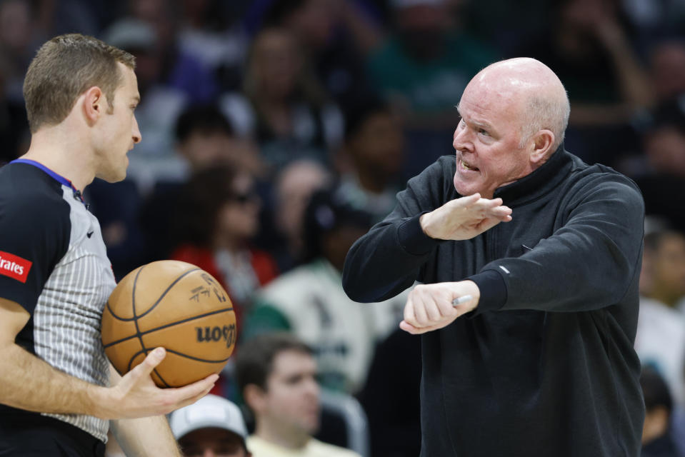 Charlotte Hornets head coach Steve Clifford, right, argues with referee Brandon Schwab for a foul during the first half of an NBA basketball game against the Boston Celtics in Charlotte, N.C., Monday, April 1, 2024. Clifford received a technical foul. (AP Photo/Nell Redmond)