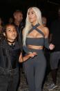 <p>Out and about in Portofino on 20 May, Kim Kardashian rocks waist-grazing peroxide blonde hair and a form-fitting bodycon two-piece. North West wears a statement cross necklace. </p>