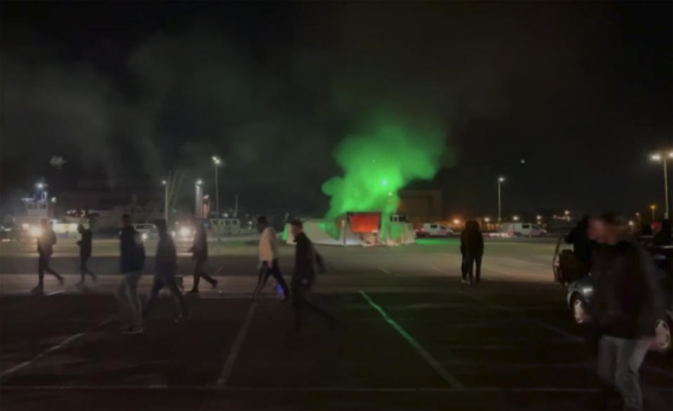 In this image made from video, a COVID-19 testing center is seen after being set on fire in Urk, 80 kilometers (50 miles) northeast of Amsterdam, Saturday, Jan. 23, 2021. Dutch police have clashed with protesters demonstrating against the country’s lockdown in the capital, Amsterdam and the southern city of Eindhoven. The unrest comes a day after rioting youths protesting on the first night of the country’s curfew torched a coronavirus testing facility in Dutch fishing village Urk. (Pro News via AP)